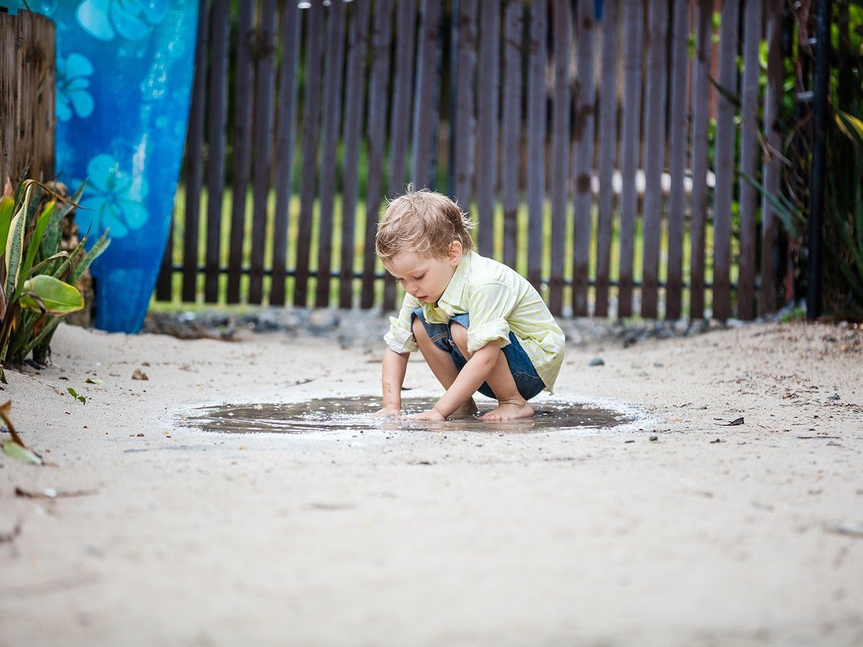 Kid playing the mud