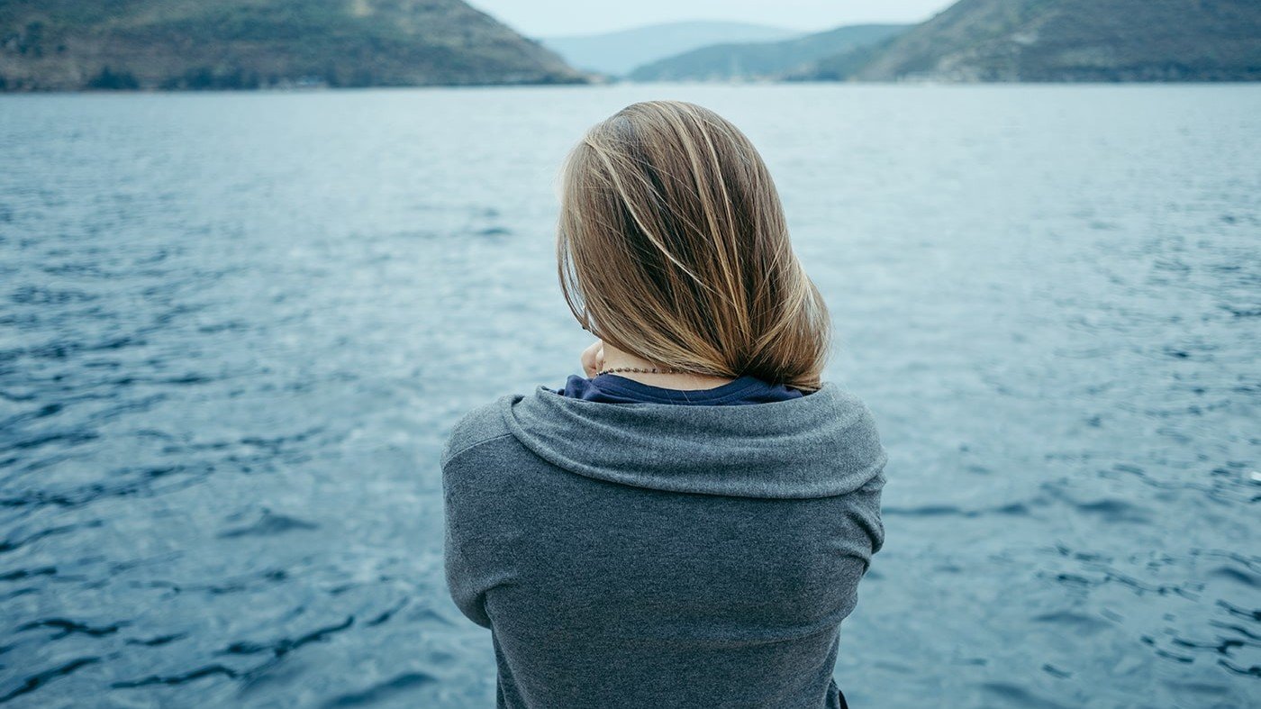 Woman looking out at lake thinking about Using Immunoglobulins For Skin Problems