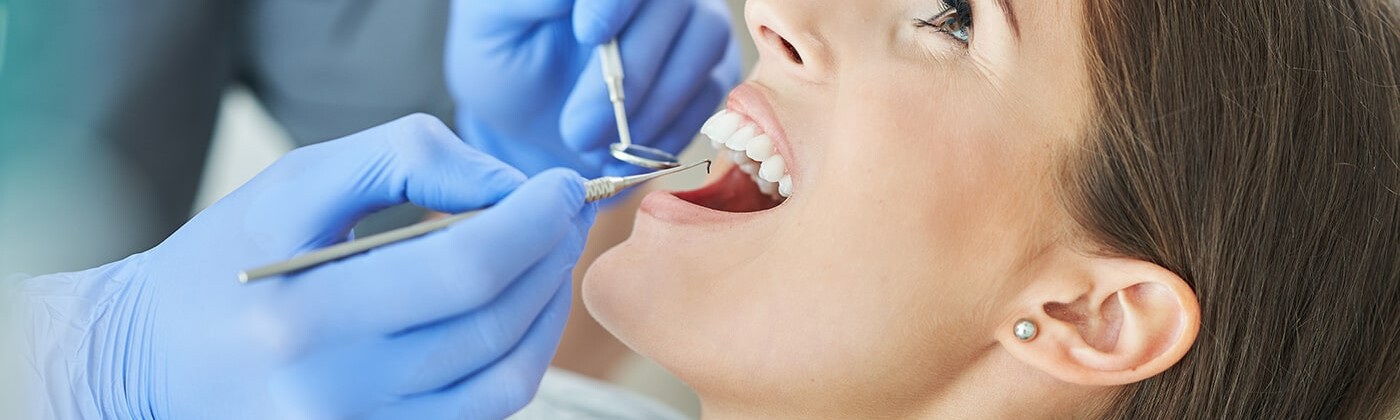 Woman having teeth cleaned at dentist