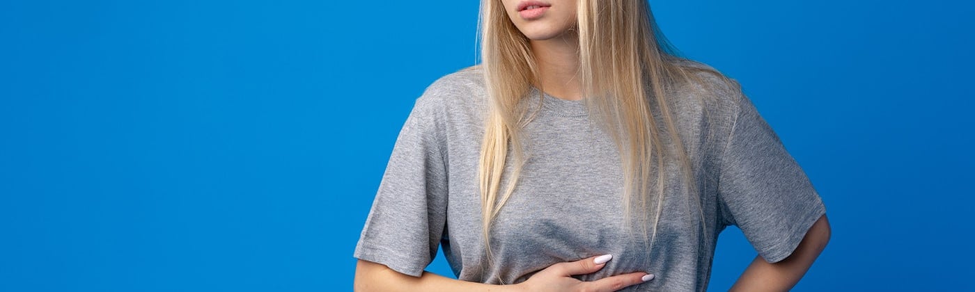 woman with stomach pain from gut parasites