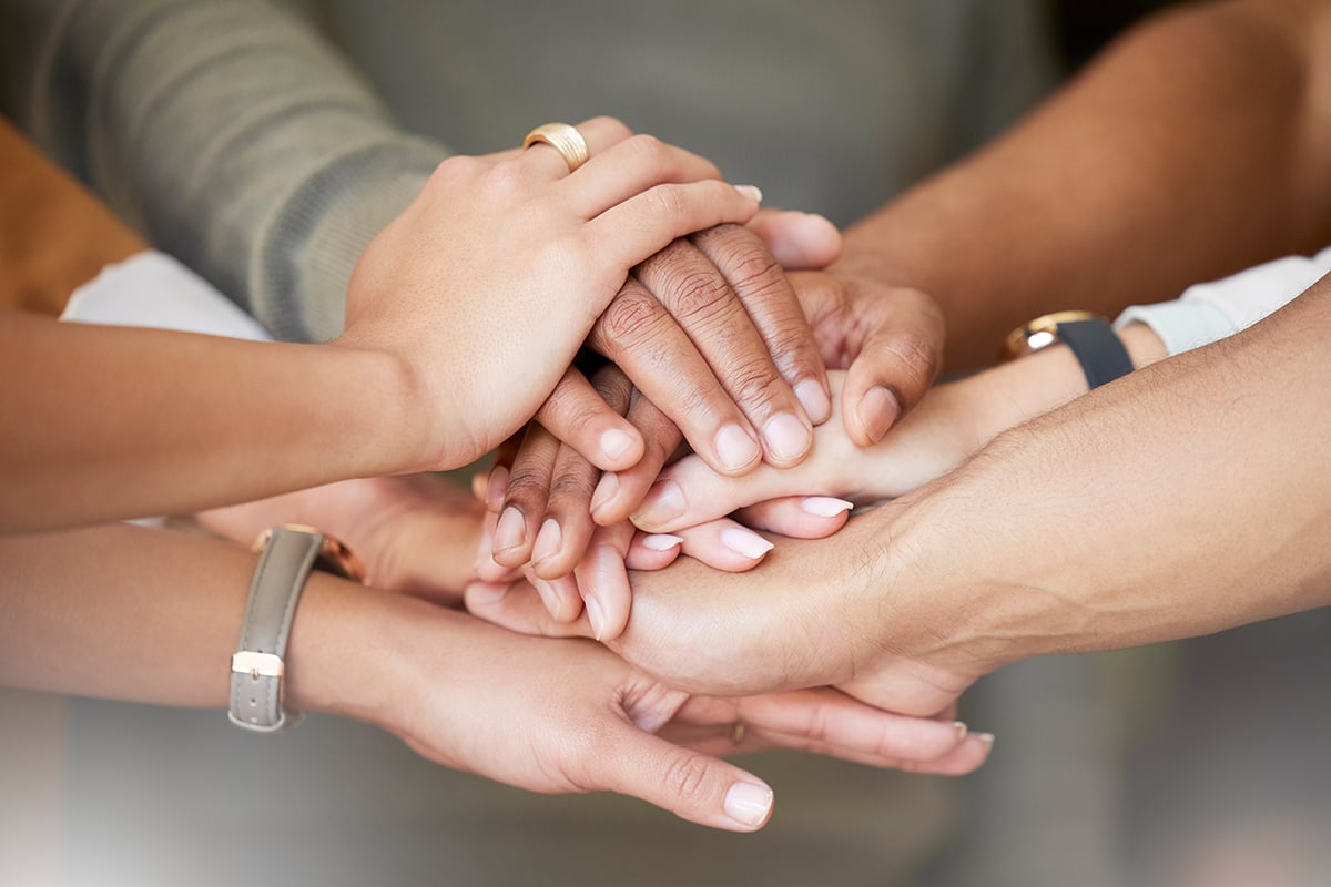 hands with eczema supporting each other