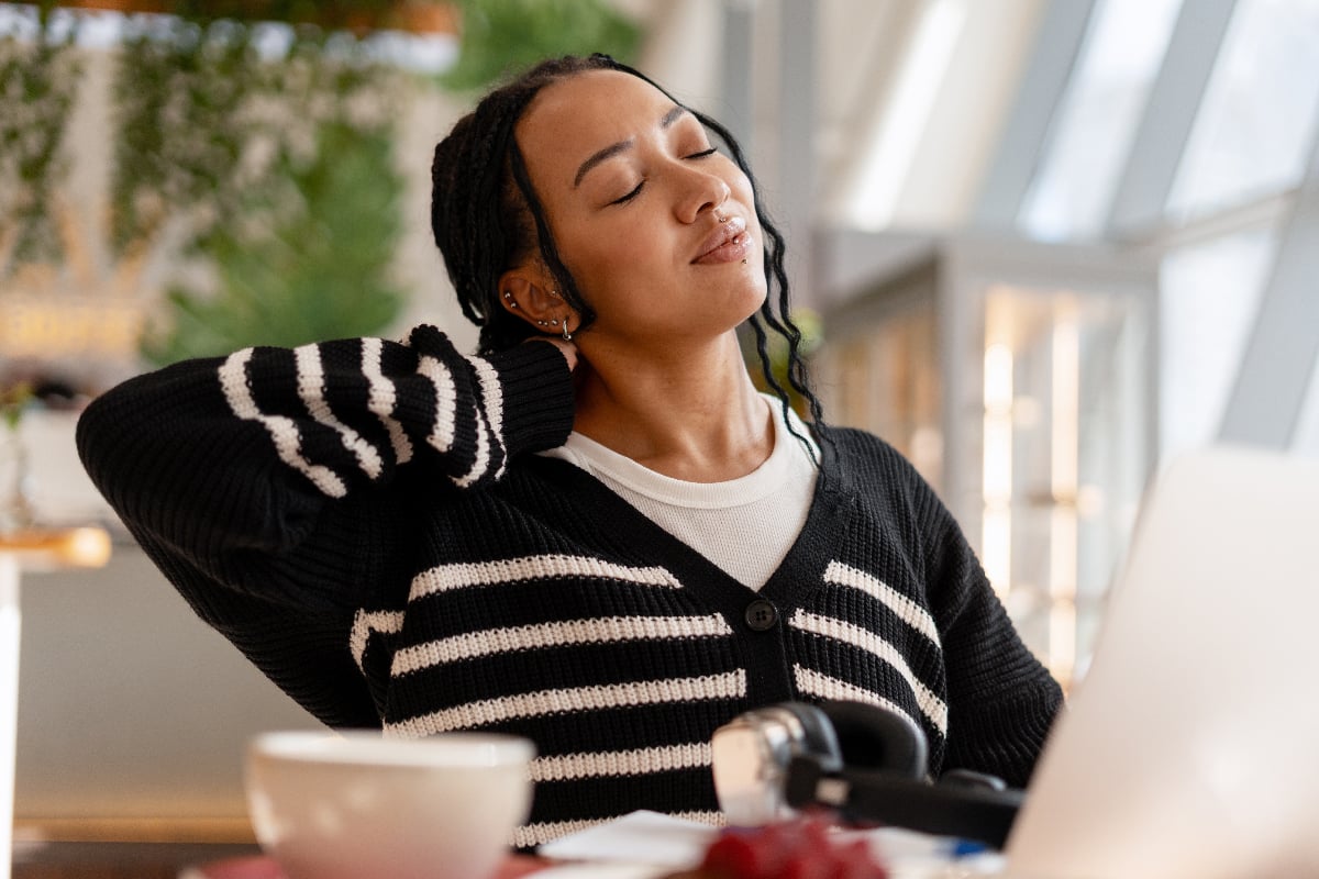 woman pausing before taking probiotics